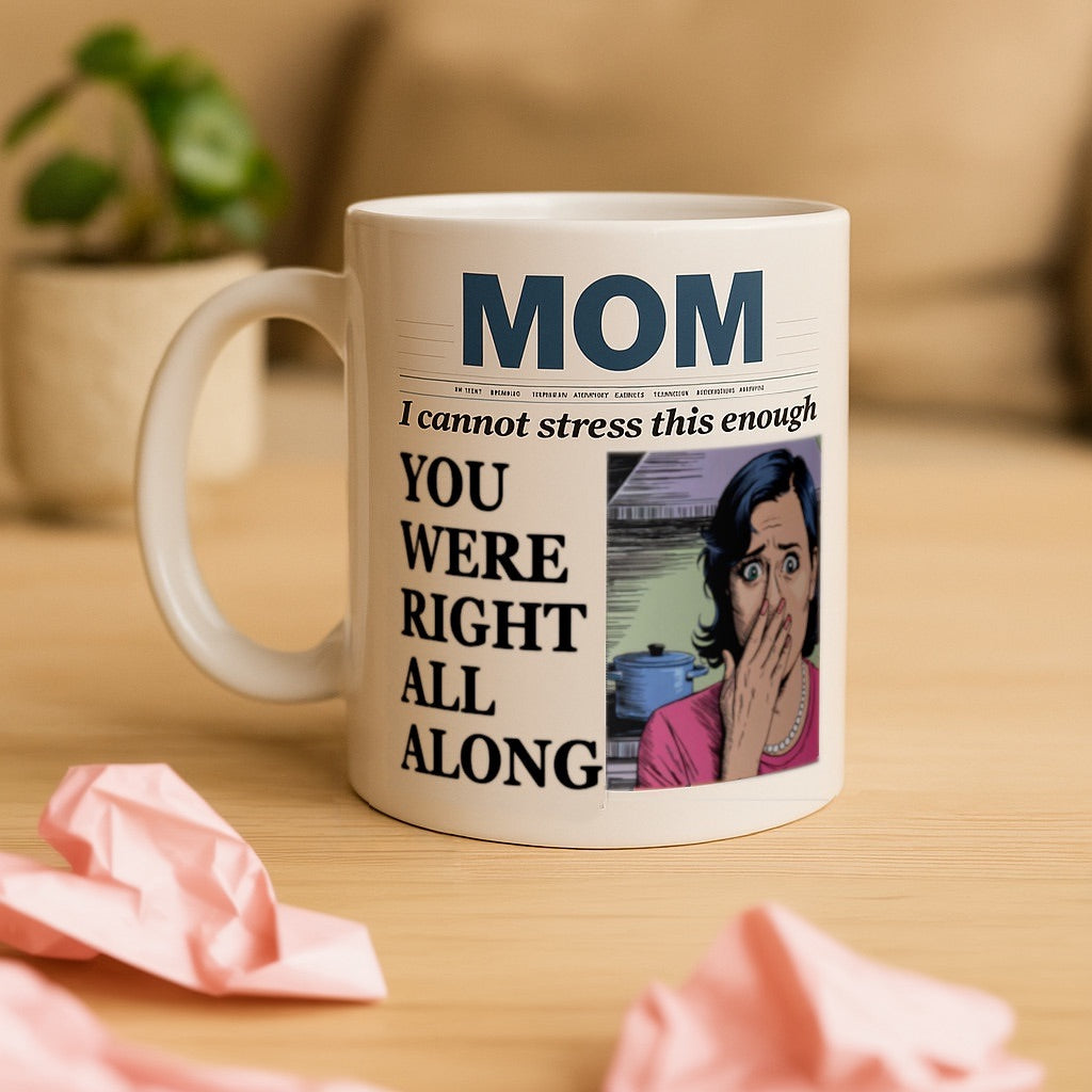 Funny mom mug styled like a newspaper front page, with bold headline text reading ‘MOM – I cannot stress this enough – YOU WERE RIGHT ALL ALONG’ and a pop-art style illustration of a surprised woman. Ceramic coffee cup placed on a wooden table with crumpled paper and houseplant in background. Perfect gift for mom from adult child, great for Mother’s Day, birthday, or just because.