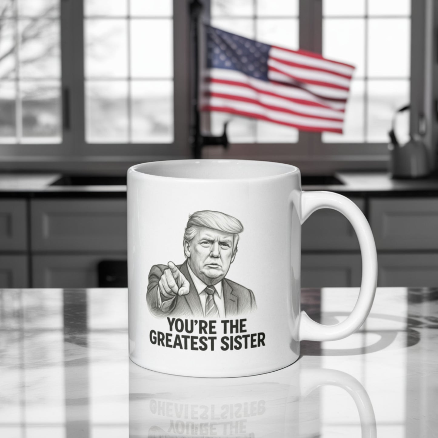 A white ceramic mug on a kitchen counter with a black-and-white illustration resembling Donald Trump pointing forward. The text on the mug reads "YOU'RE THE GREATEST SISTER" in bold capital letters. In the background, an American flag is prominently displayed near a sunlit window, adding a dramatic and patriotic flair to the scene.