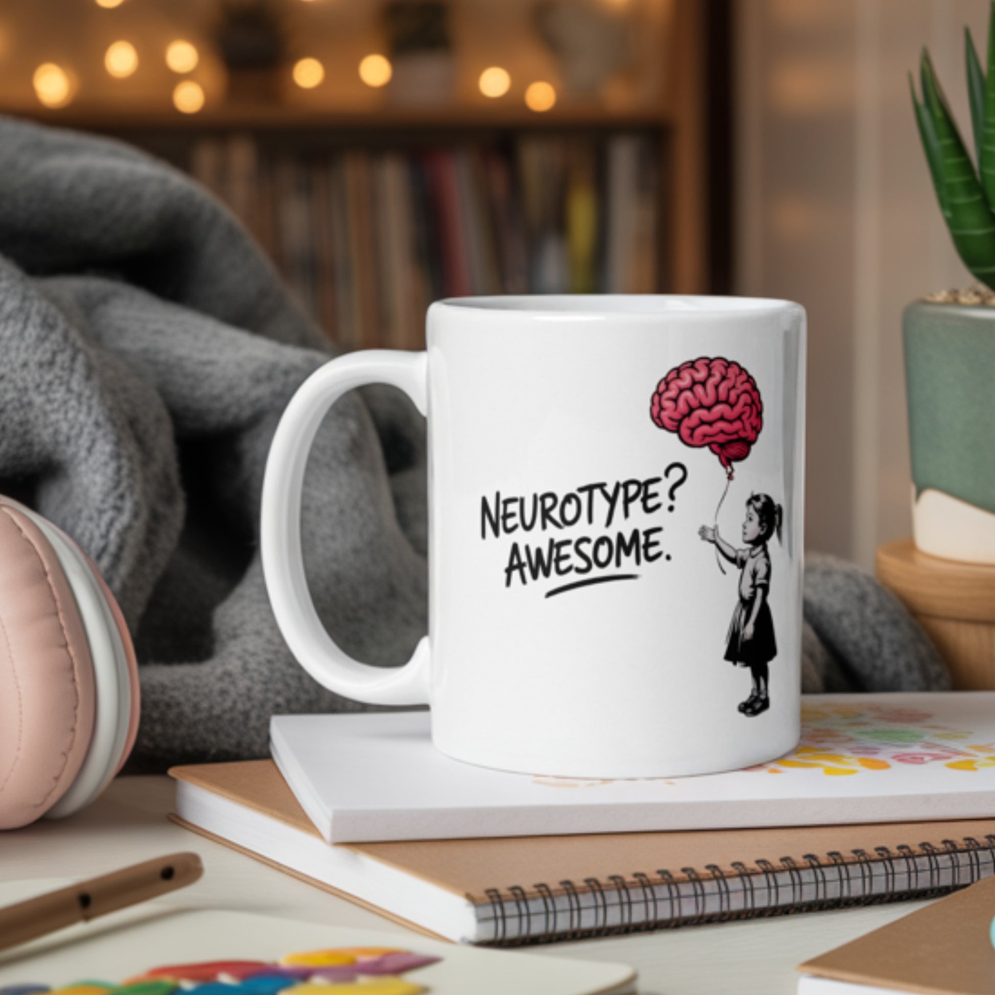 White ceramic “Neurotype? Awesome.” mug featuring a cartoon girl holding a red brain-shaped balloon—perfect for neurodivergent pride, ADHD gifts, or autistic affirmations. Surrounded by notebooks and cozy décor, this empowering mental health coffee mug makes a bold, funny statement about neurodiversity, self-acceptance, and brain-based identity.