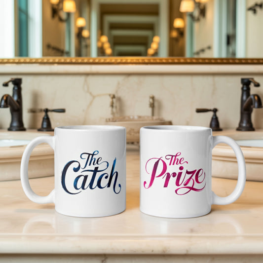 Two white ceramic couples mugs on a luxurious marble bathroom vanity—one labeled "The Catch" in blue and the other "The Prize" in pink—styled as playful his and hers mugs for romantic partners. A perfect example of mr and mrs mugs or couples mugs for gifting or everyday use.
