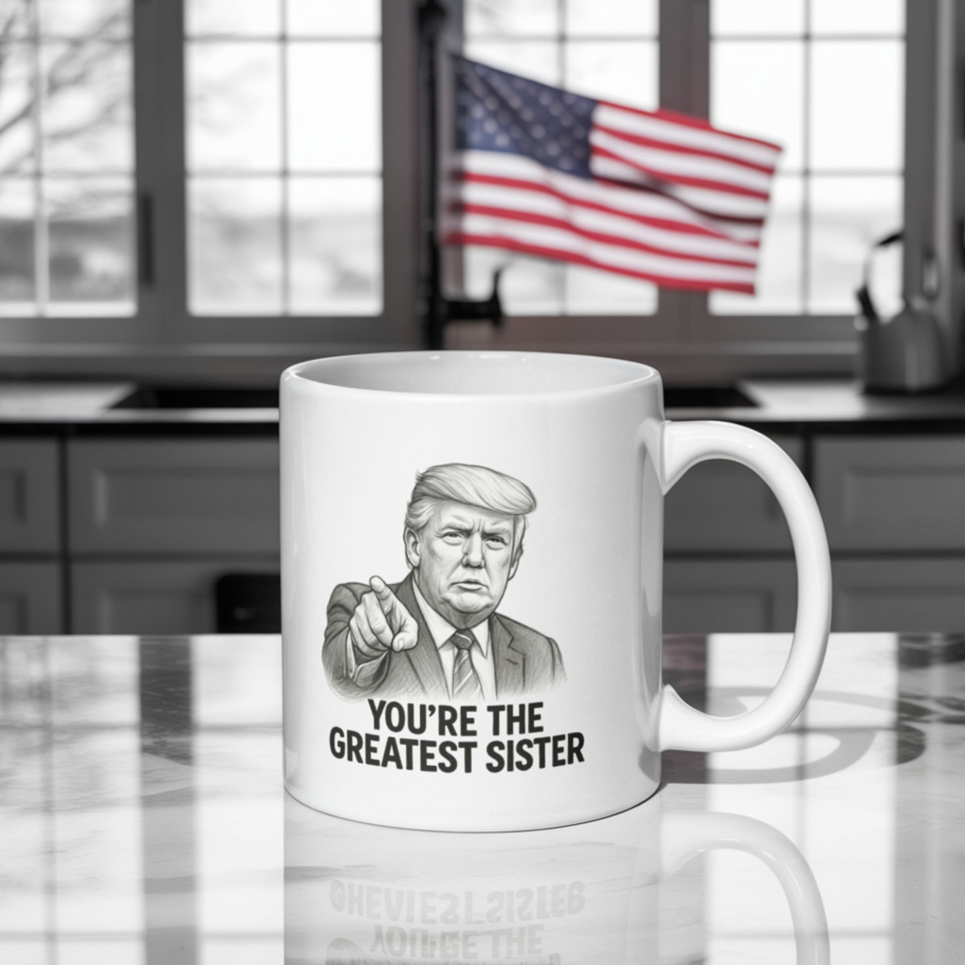 A white ceramic mug on a kitchen counter with a black-and-white illustration resembling Donald Trump pointing forward. The text on the mug reads "YOU'RE THE GREATEST SISTER" in bold capital letters. In the background, an American flag is prominently displayed near a sunlit window, adding a dramatic and patriotic flair to the scene.